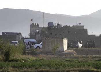 Afghan security forces stand guard on the roof of the main prison building after a Taliban attack in Ghazni. Photograph: Rahmatullah Nikzad/AP