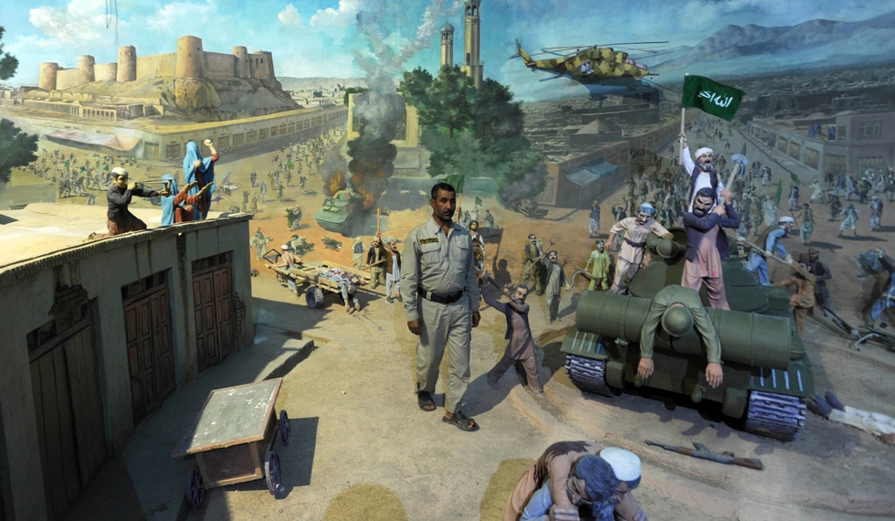 An employee of the Manzar-e-Jahad (Jihad Museum) poses in front of a diorama depicting the Mujahedin war against the Soviet Union in Herat on April 27, 2012. The museum commemorates the 1979 uprising of Heratis against Soviet political advisors in the city and the ensuing Afghan conflict with the Russians. AFP PHOTO/ AREF KARIMI / AFP PHOTO / Aref Karimi