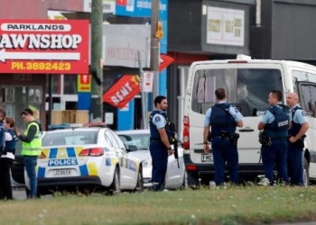 Police stand outside a mosque in Linwood, Christchurch, New Zealand, Friday, March 15, 2019. Multiple people were killed during shootings at two mosques full of people attending Friday prayers. (AP Photo/Mark Baker)