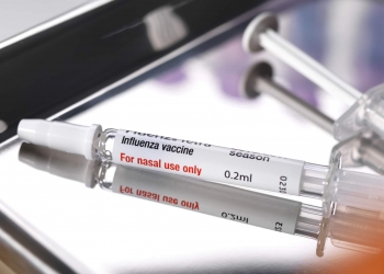Nasal influenza vaccine on a medical tray.